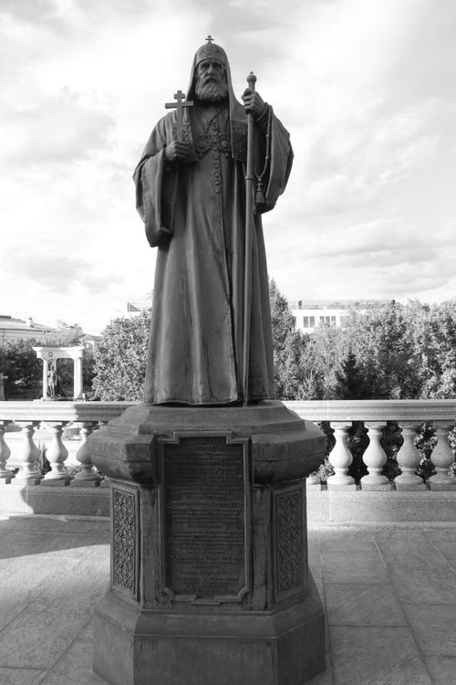 Free Black and white photo of a statue depicting a religious figure outdoors. Stock Photo