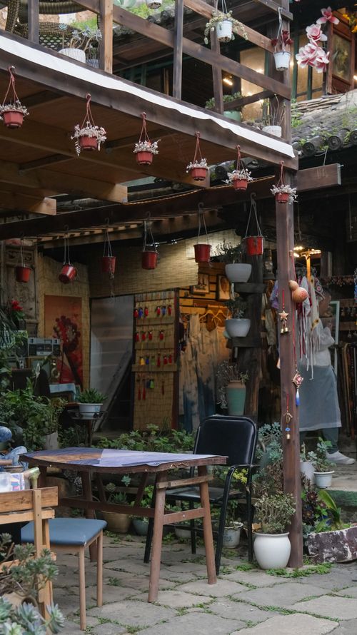 Free Charming outdoor garden cafe featuring hanging plants and rustic decor. Stock Photo
