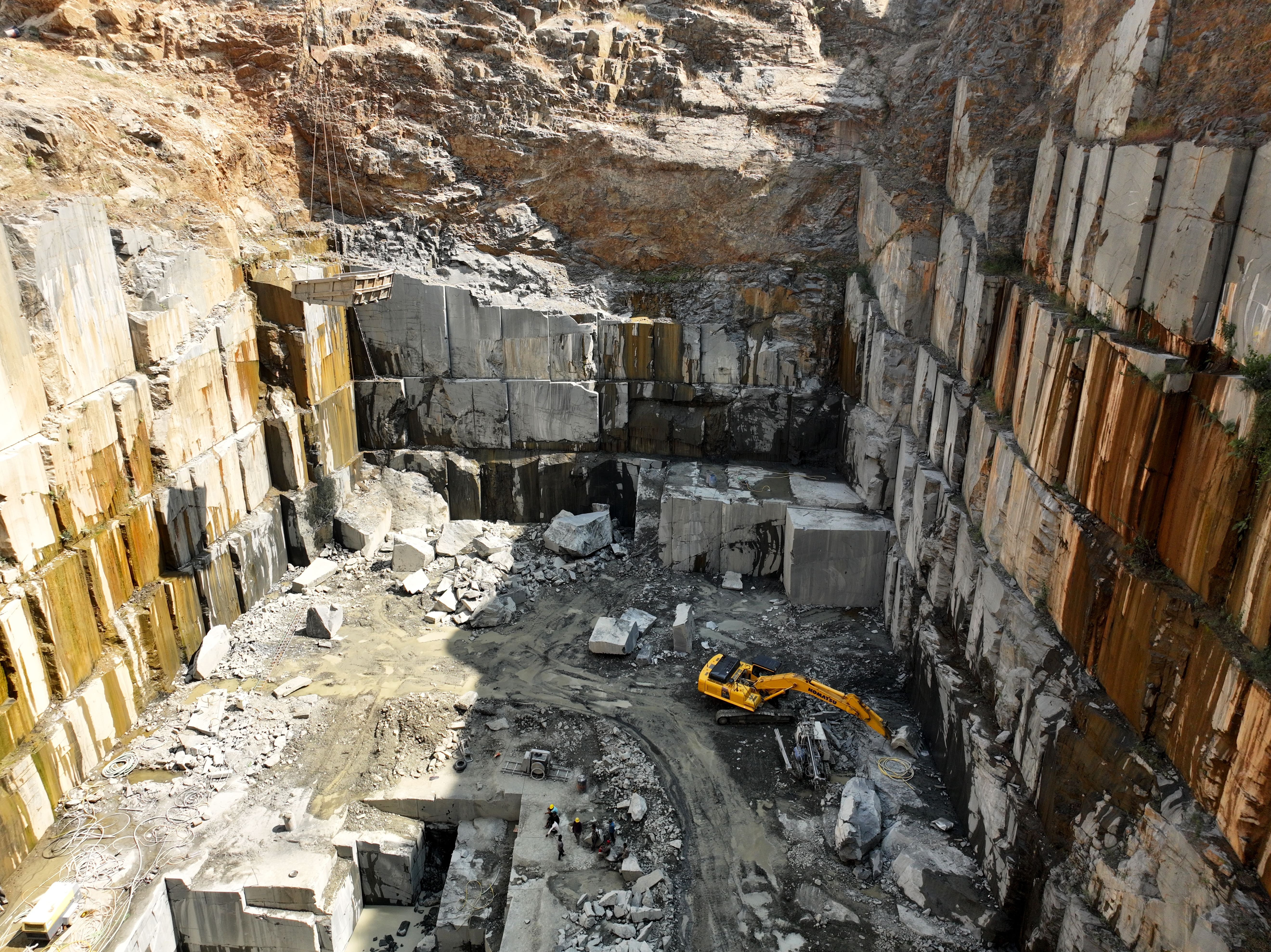 Granite quarry with excavator — Iranian stone industry overview 2026 quarries capacity and export outlook
