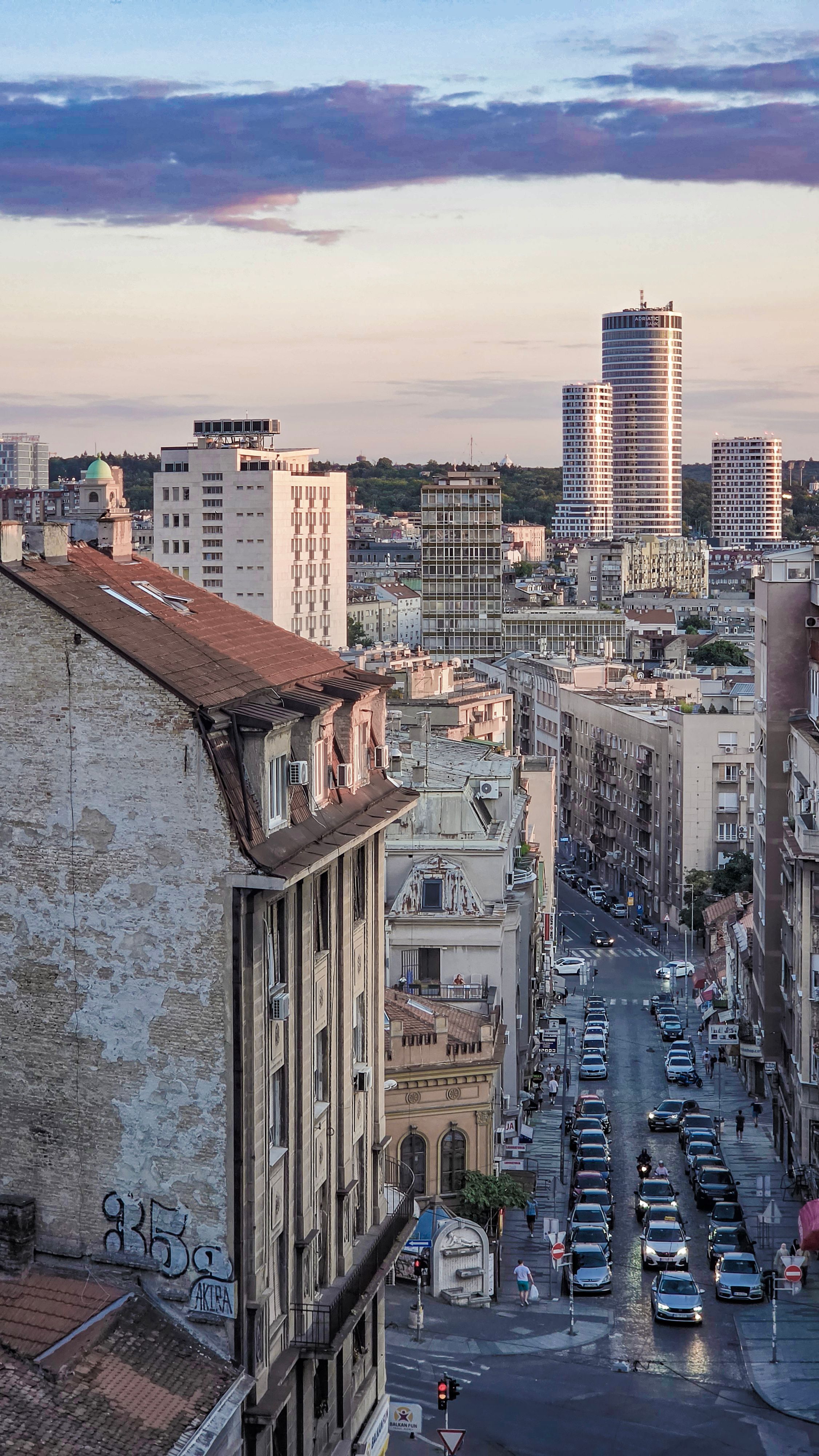 Aerial view of Belgrade's urban architecture at dusk, showcasing modern and historic buildings.