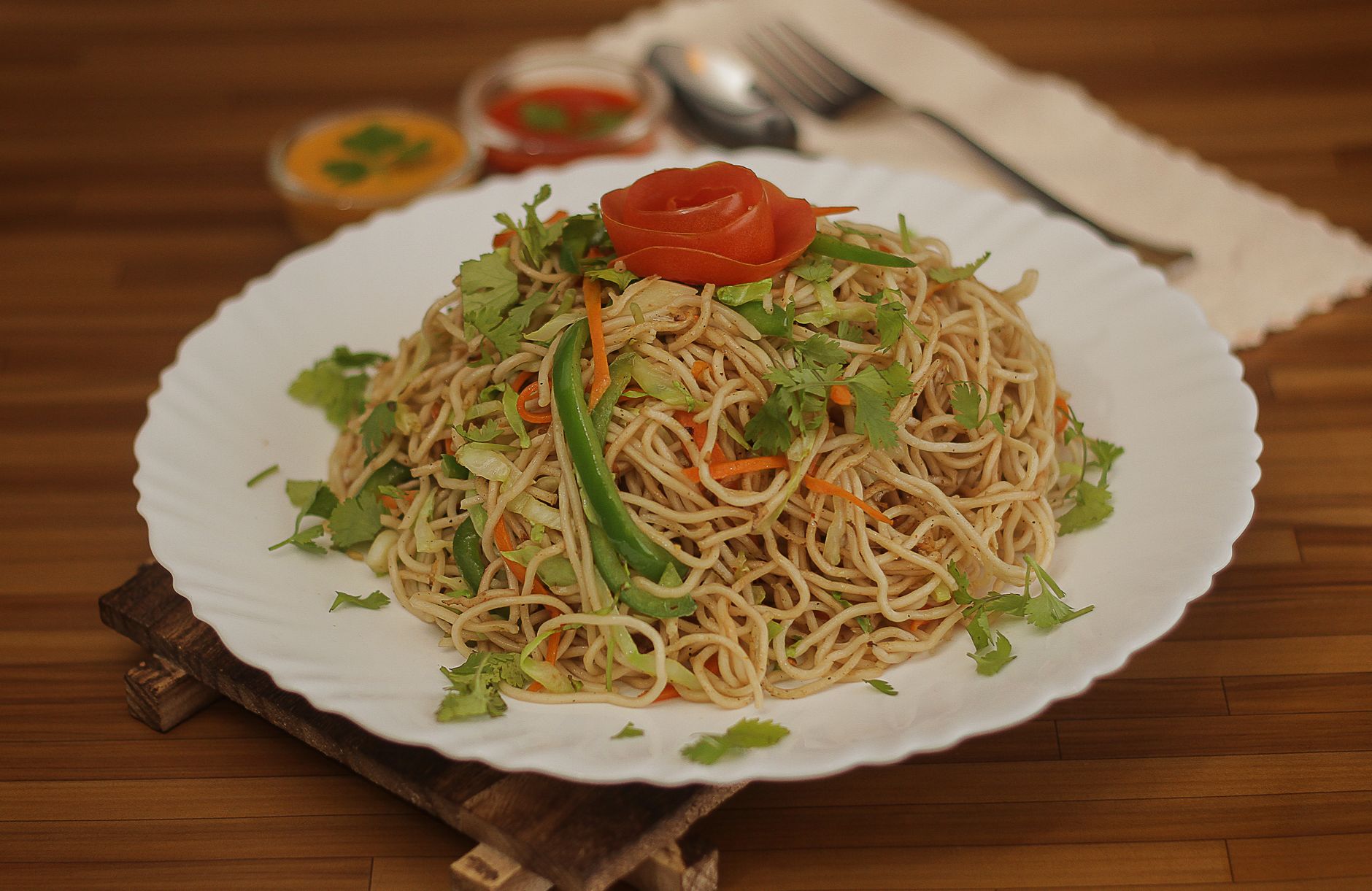 Fresh vegetables and noodles being stir fried in wok