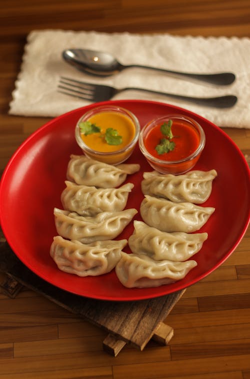 Free Dumplings On A Red Plate Stock Photo