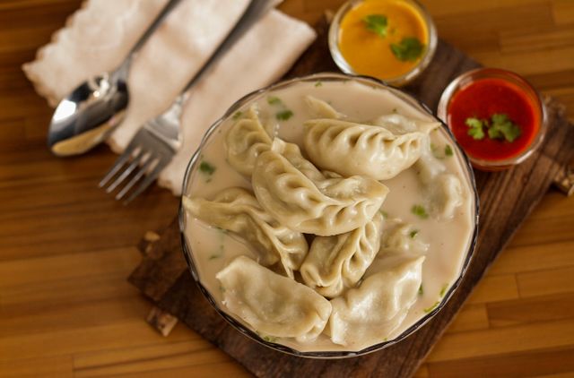 Nepalese Jhol Momo served in savory broth with vibrant sauces. A culinary treat from Itahari.