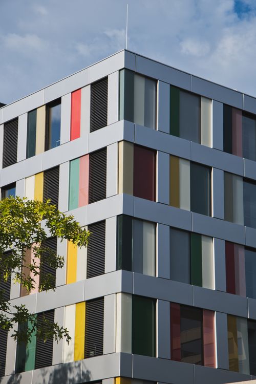Free Vibrant facade of a modern office building in Berlin with colorful panels. Stock Photo