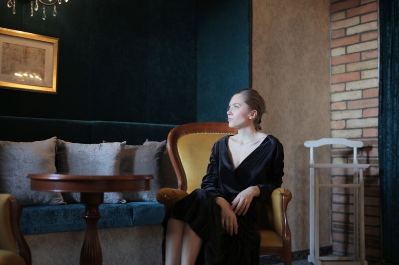 Woman seated in an armchair, photo by Andrea Piacquadio on Pexels