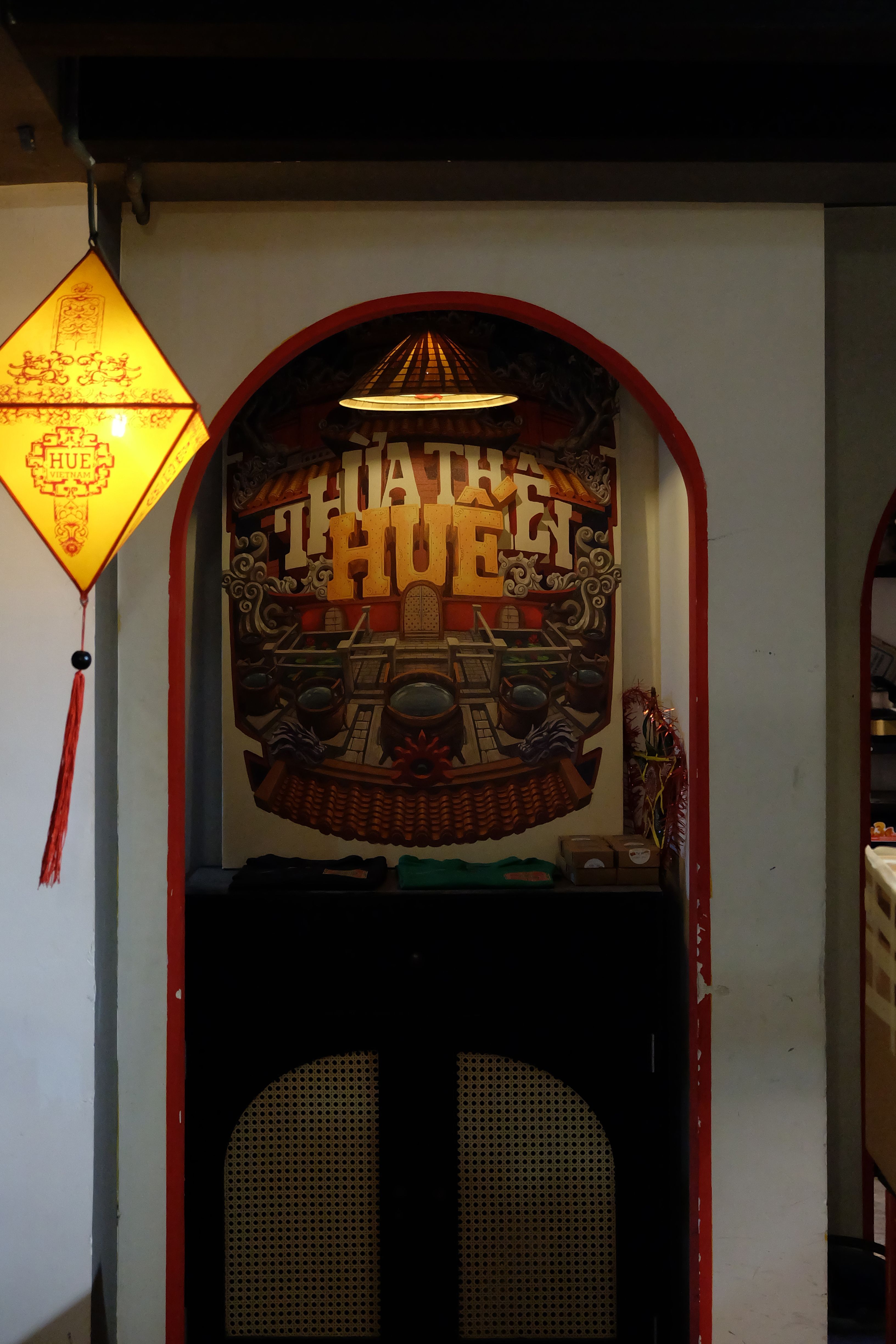Vietnamese decor featuring traditional lanterns and artwork in an indoor setting.