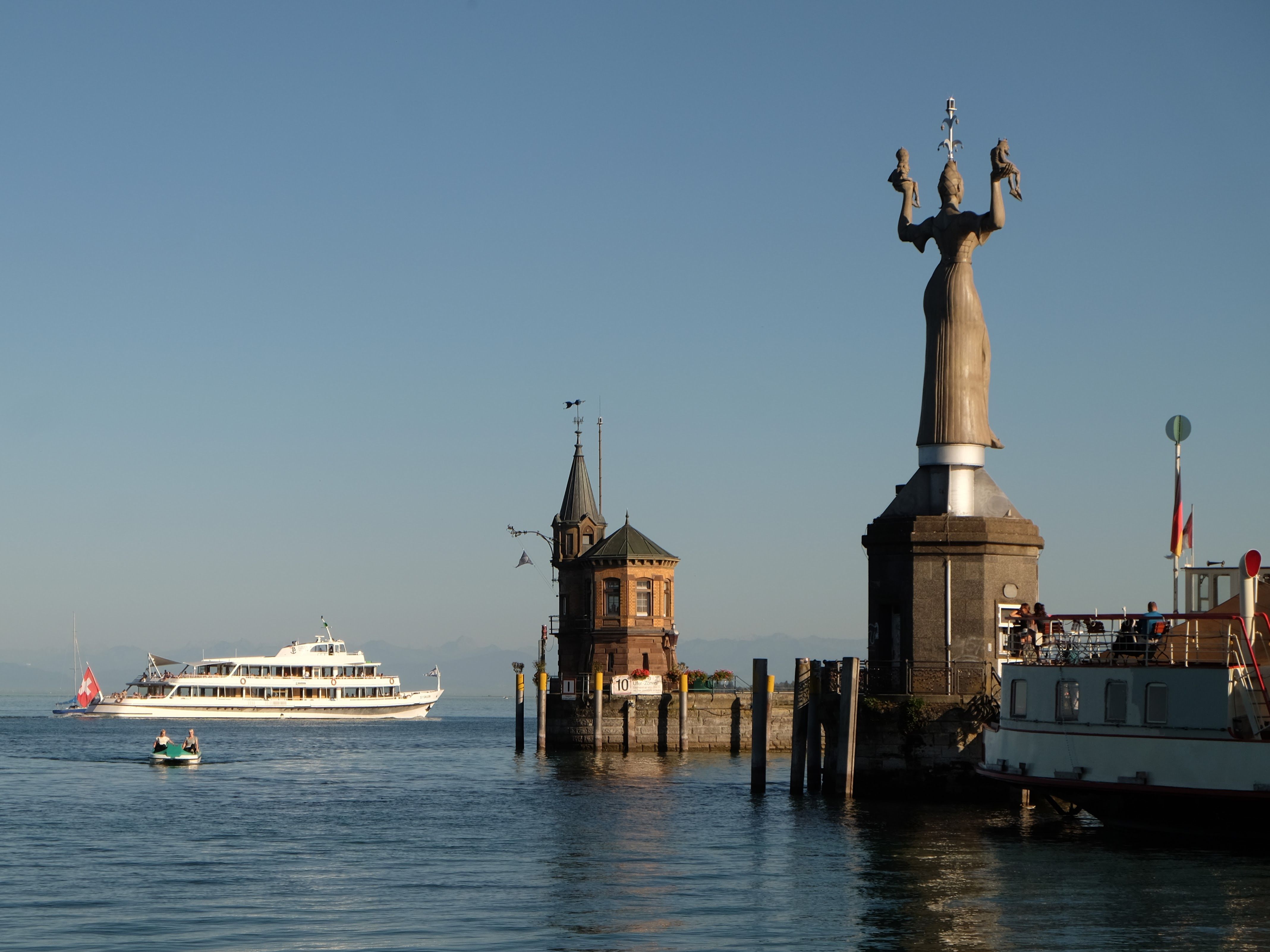 Capture of Imperia statue with boats and clear skies at Lake Constance.