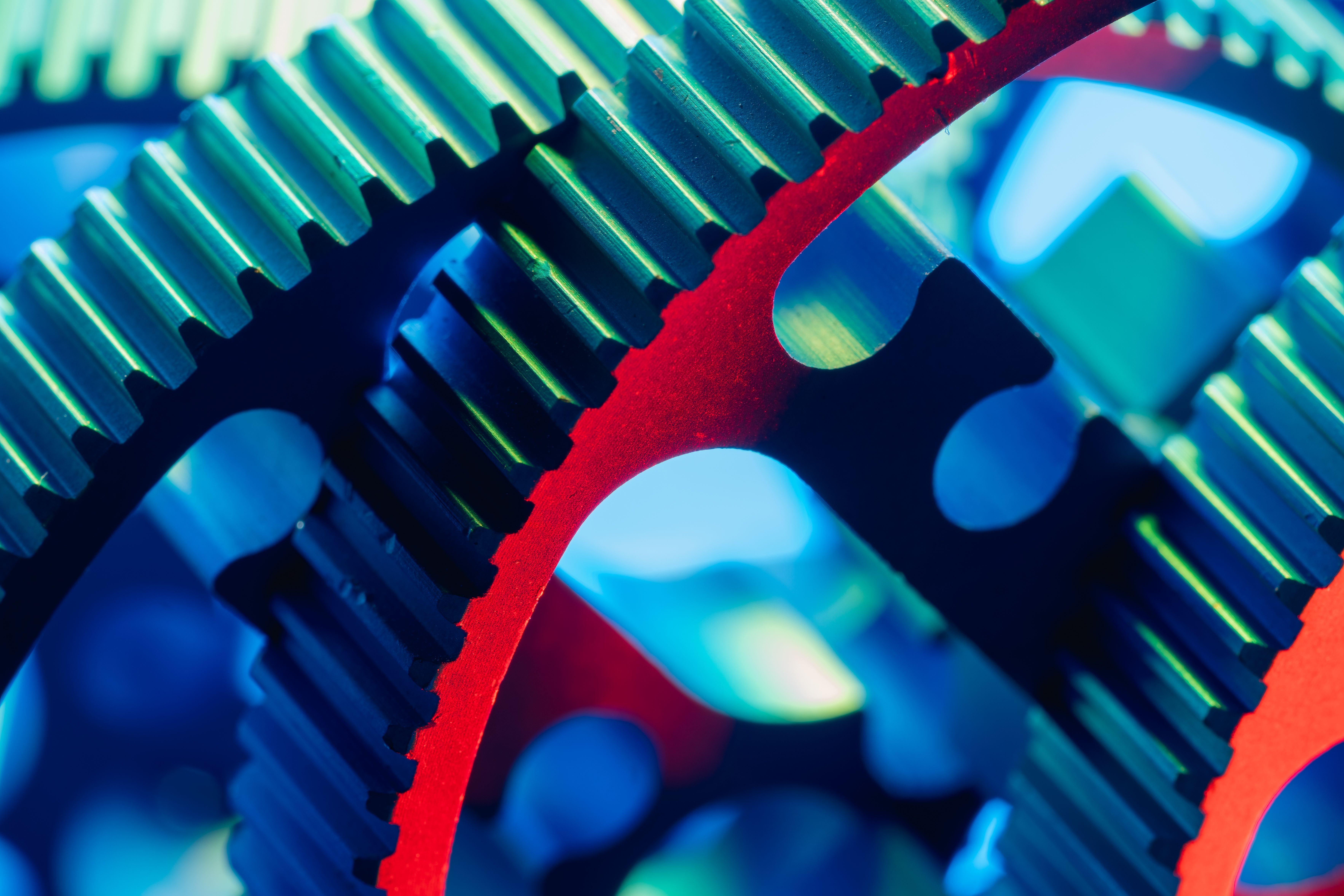Vibrant close-up photograph of colorful interlocking gears showcasing precision and engineering.