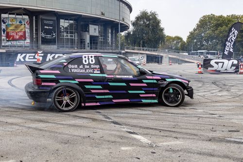 Free Colorful car drifting at Beograd Fair, showcasing dynamic street racing excitement. Stock Photo