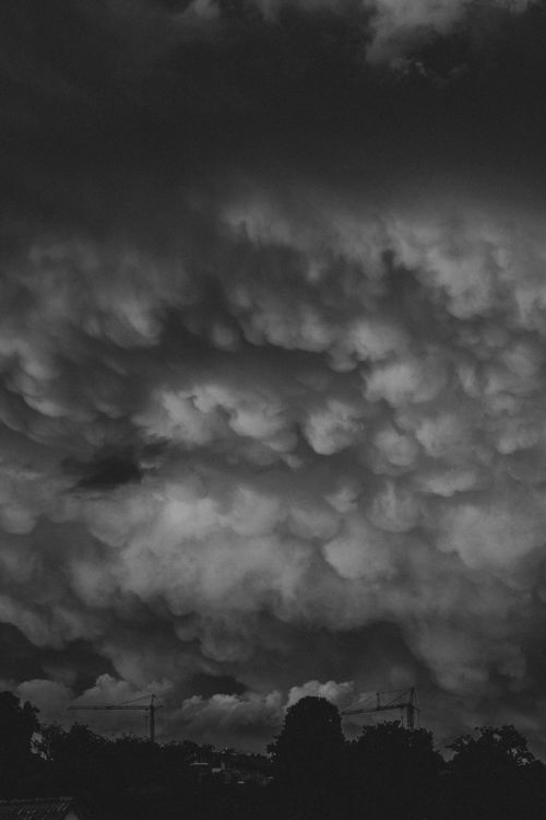 Free A striking view of stormy mammatus clouds in a moody black and white tone. Stock Photo