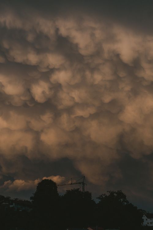 Free Stunning view of dramatic mammatus clouds forming at sunset. Stock Photo