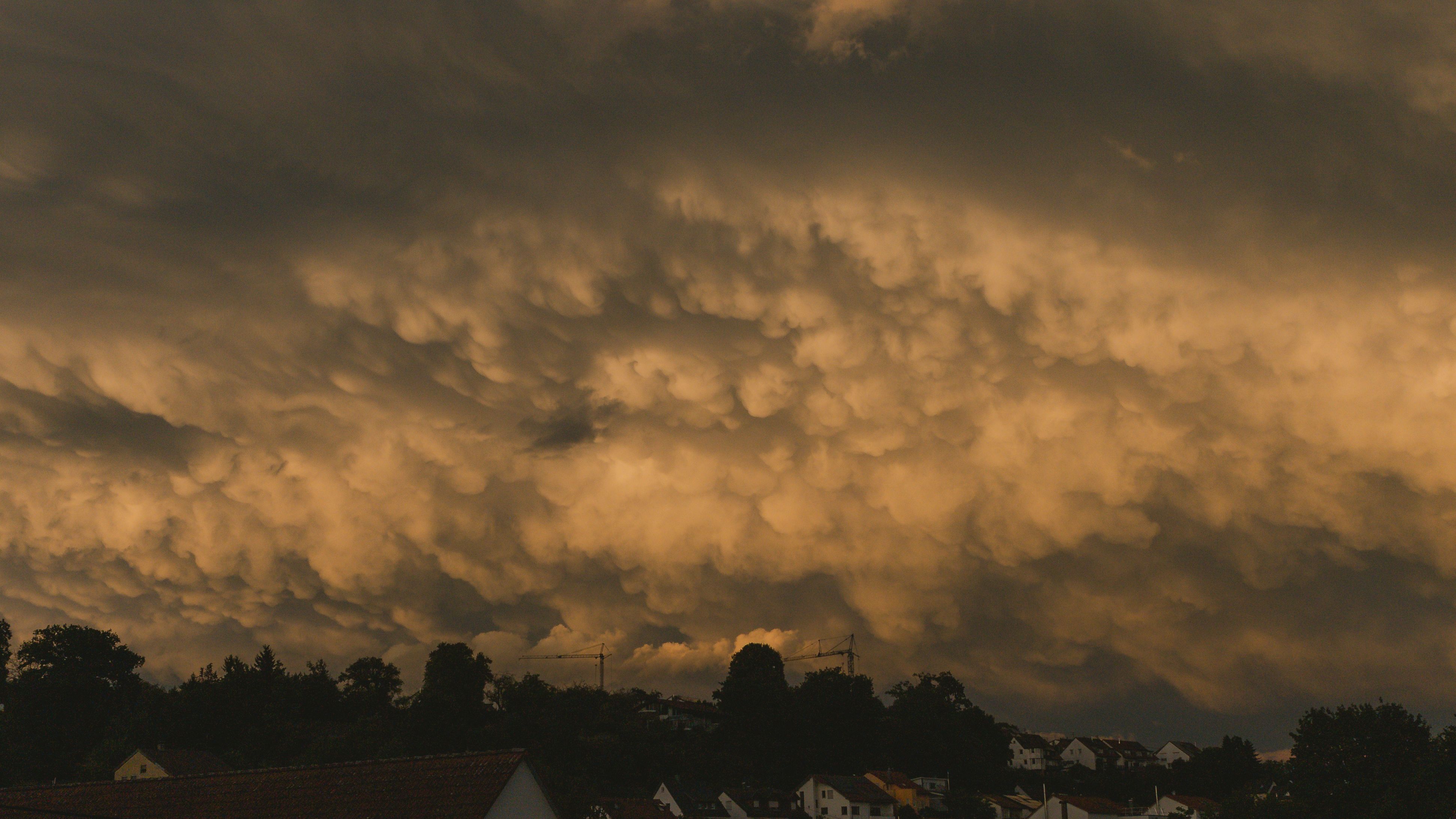 Storm clouds at twilight over suburban houses