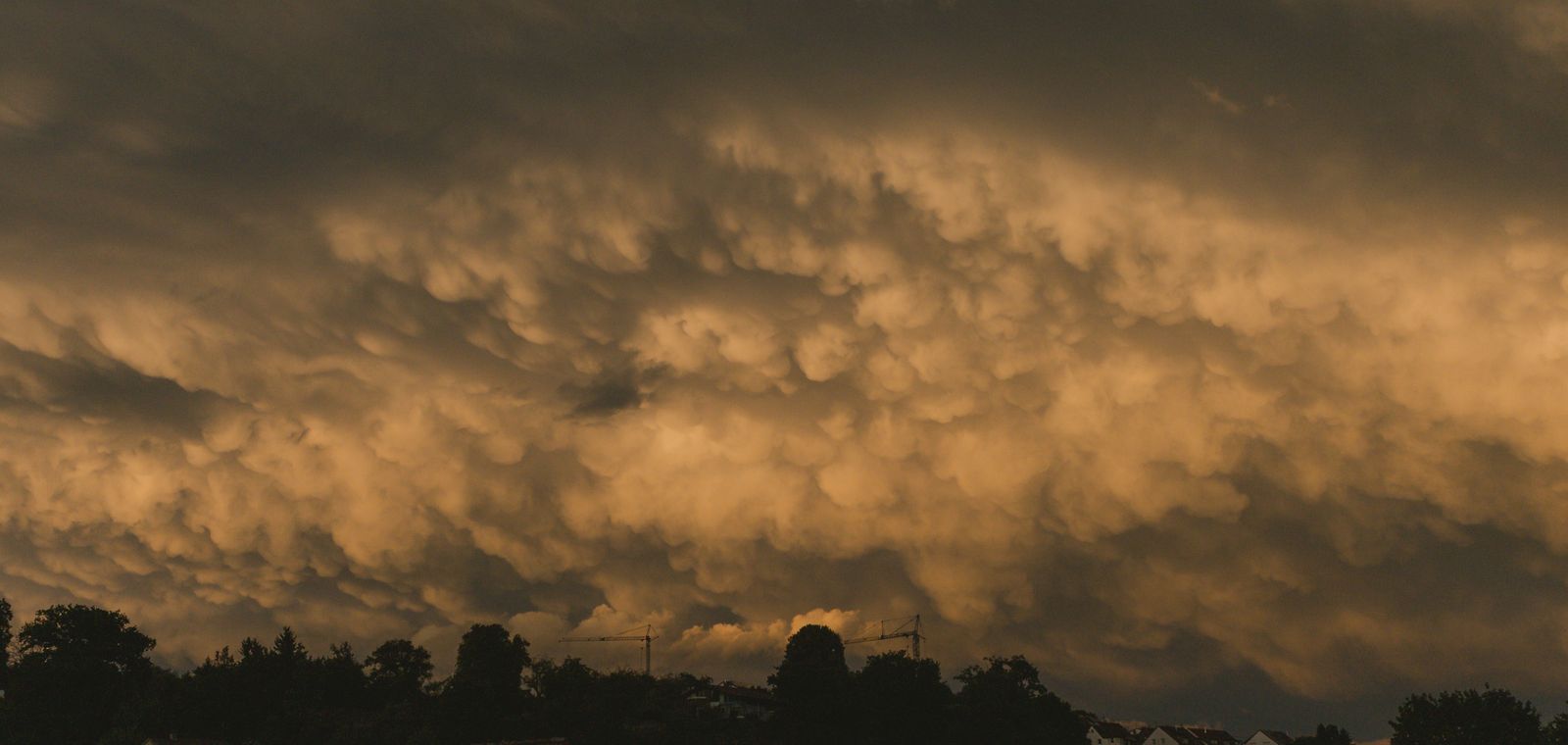 Storm clouds at twilight over suburban houses