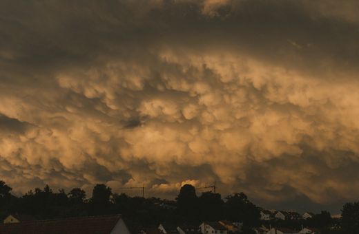 Storm clouds at twilight over suburban houses