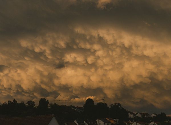 Storm clouds at twilight over suburban houses