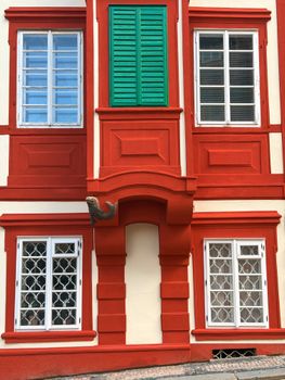 Colorful facade of a historic building in Prague with striking red and green accents.