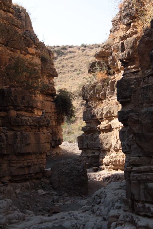 Free Explore dramatic rock formations in a rugged, sunlit canyon landscape. Stock Photo