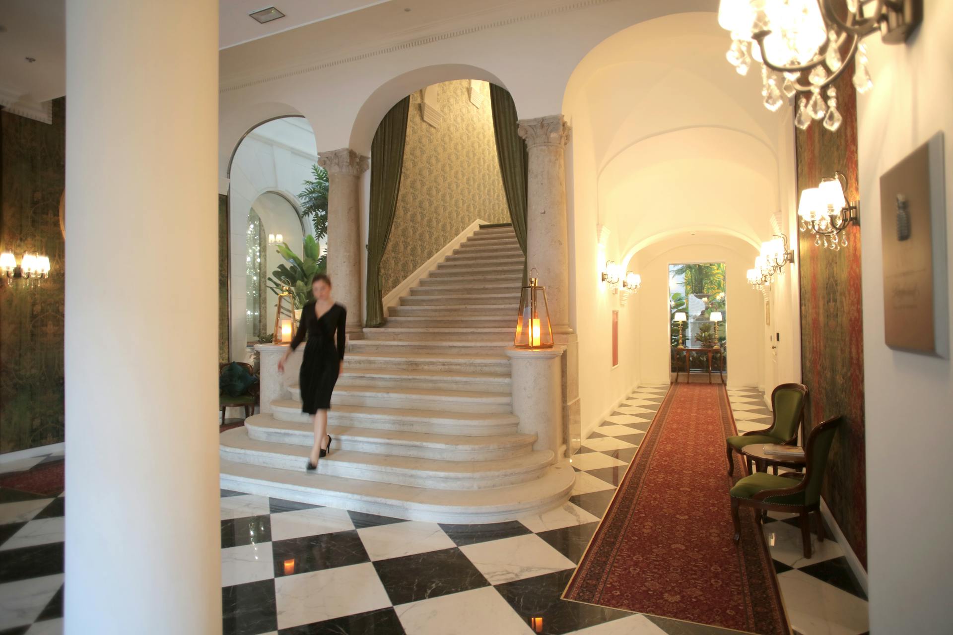 Luxurious hotel lobby featuring a grand staircase and elegant interior design