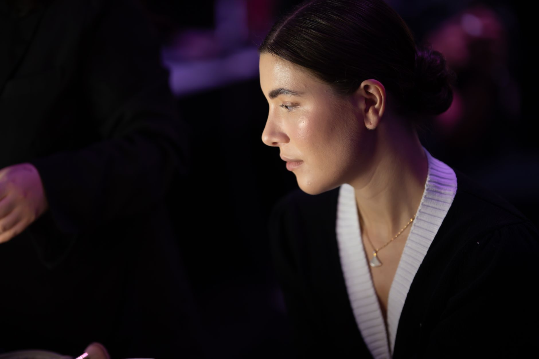 A thoughtful portrait of a woman during a backstage moment at a Dubai fashion show.