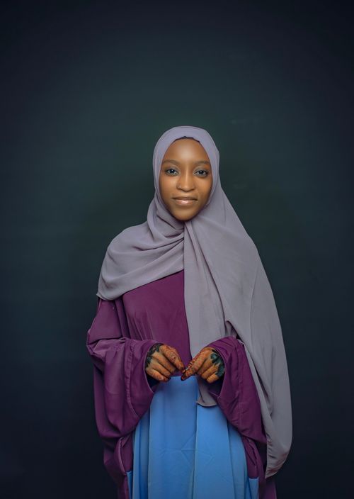 Free A serene portrait of a woman wearing a hijab, showcasing elegance and grace in traditional attire. Stock Photo