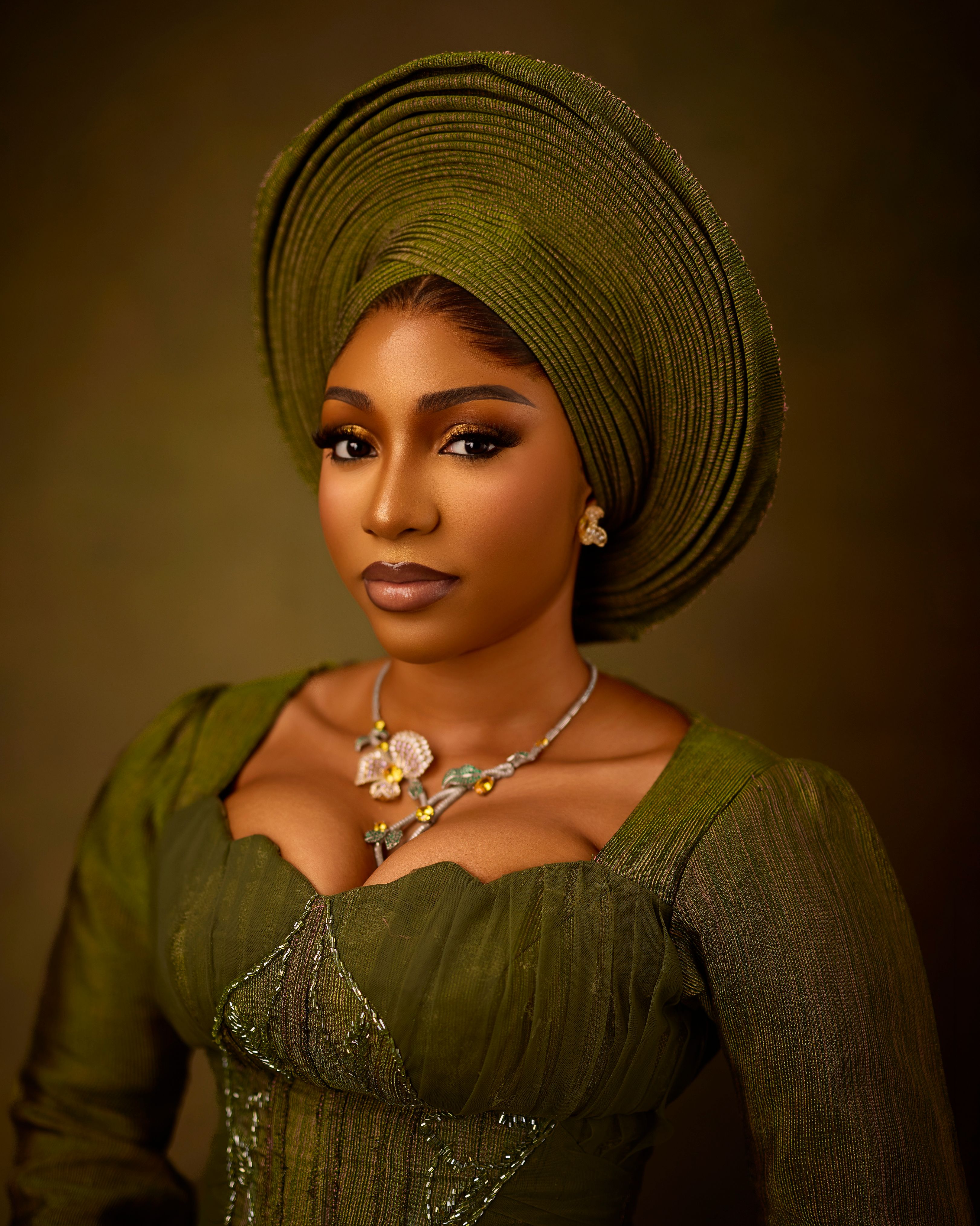 Portrait of a woman in elegant green traditional attire with jewelry.