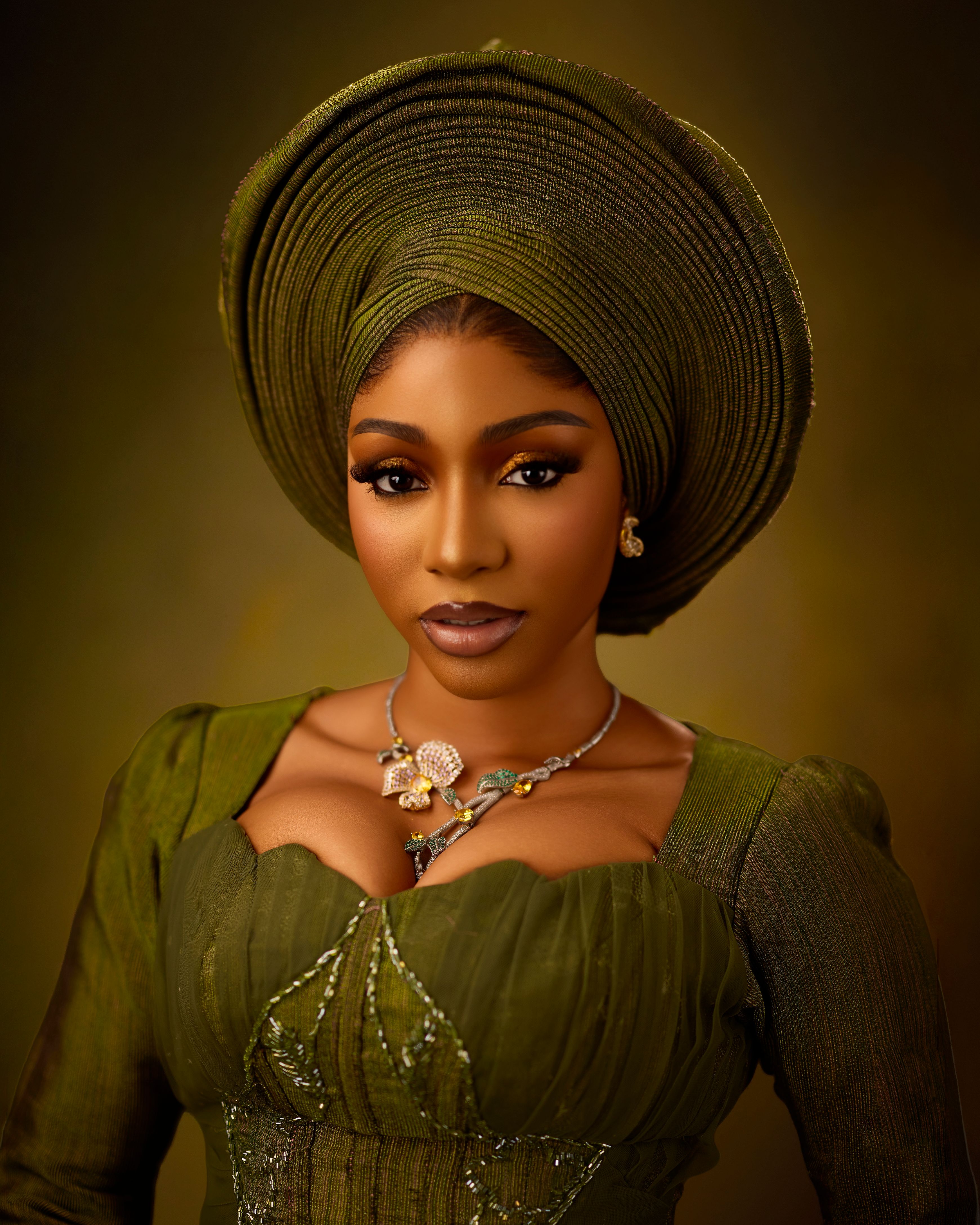 Stunning portrait showcasing a woman in traditional green attire with intricate accessories.