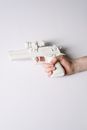 Person Holding White and Gray Semi Automatic Pistol