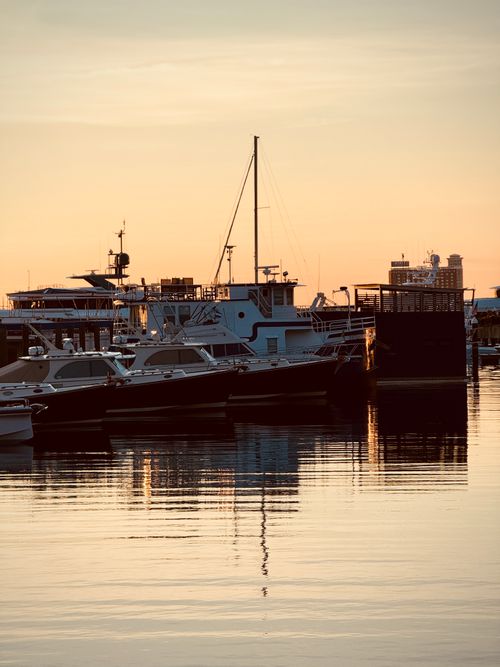 Free Peaceful sunset over boats at Boston Harbor, reflecting tranquility. Stock Photo