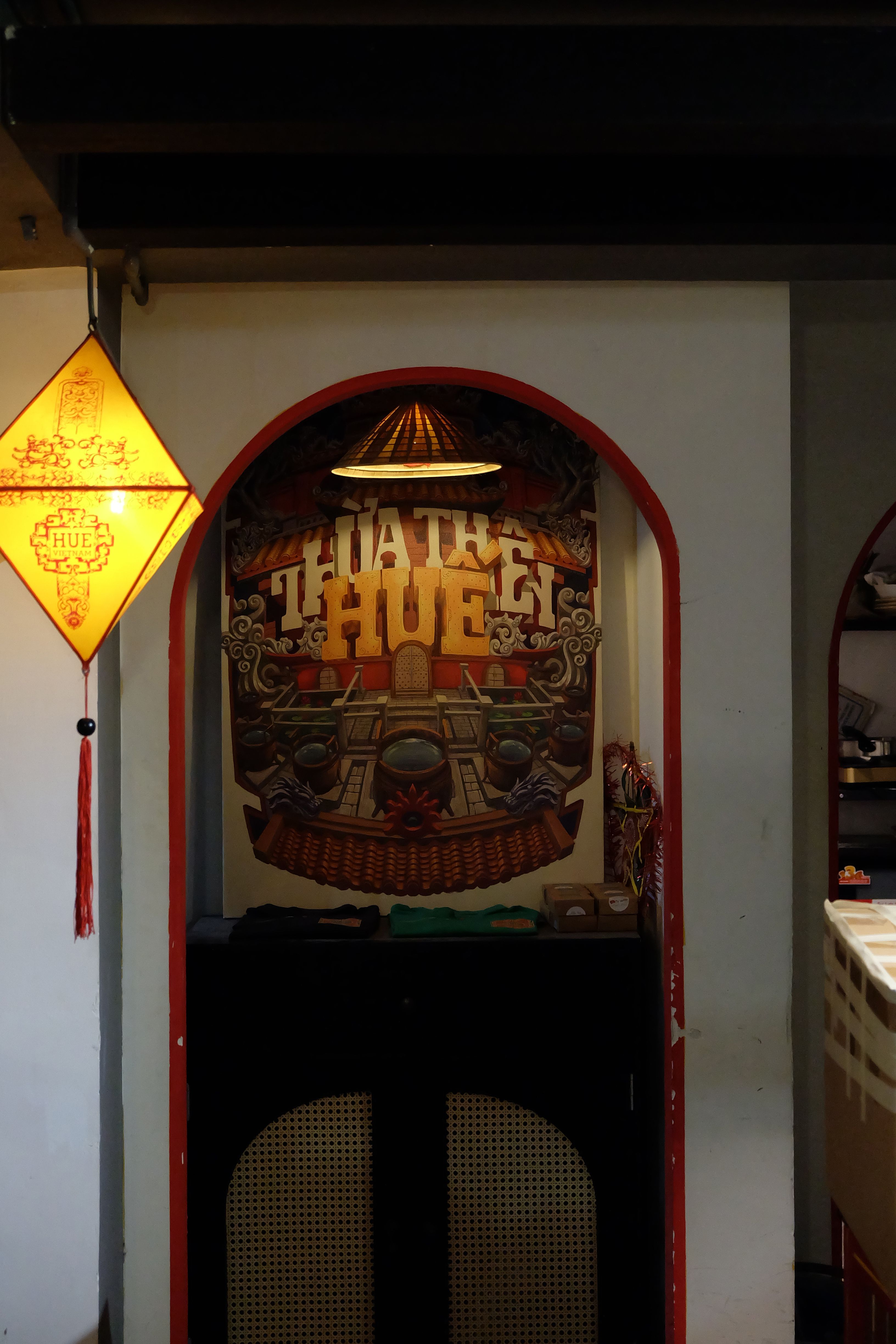 Intricate Vietnamese wall art with warm lighting indoors, showcasing Hue's cultural essence.