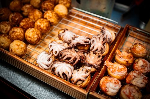 Free Close-up of takoyaki with octopus and shrimp in Bangkok street market. Stock Photo