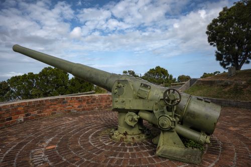 Free Aged cannon displayed on brick platform in outdoor historic fortress scene. Stock Photo
