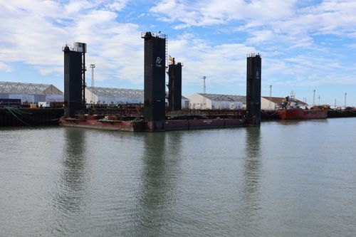 Free Industrial boats and warehouses at El Puerto de Santa María harbor, depicting a serene maritime scene. Stock Photo