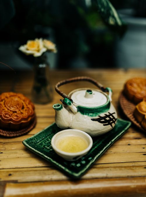 Free Charming green-tea set and mooncakes on bamboo table, Vietnamese style. Stock Photo