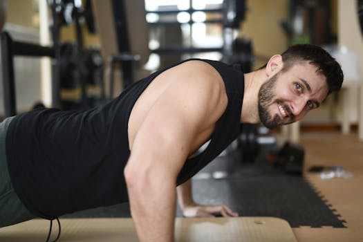 Adult male performing push-ups in a gym. Strong fitness routine showcasing effort and determination.