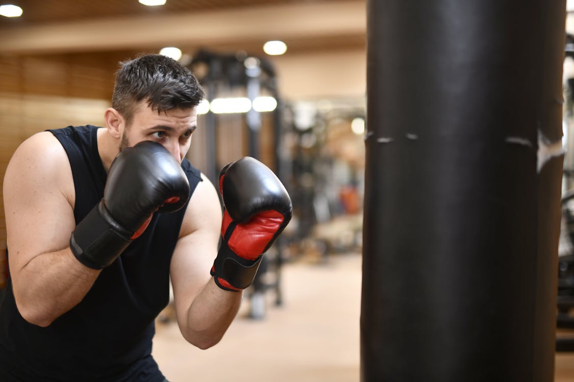 Man In Black Tank Top Wearing Black And Red Boxing Gloves