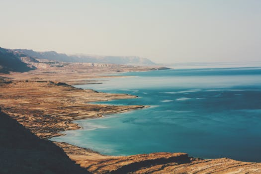 A breathtaking aerial view of the Dead Sea's coastline, capturing its rugged beauty and serene blue waters.