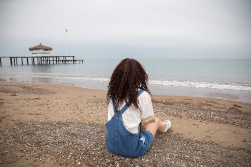 Free Woman Sitting By The Beach Stock Photo