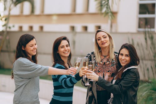 Free Women Smiling And Holding Drinking Glasses Stock Photo