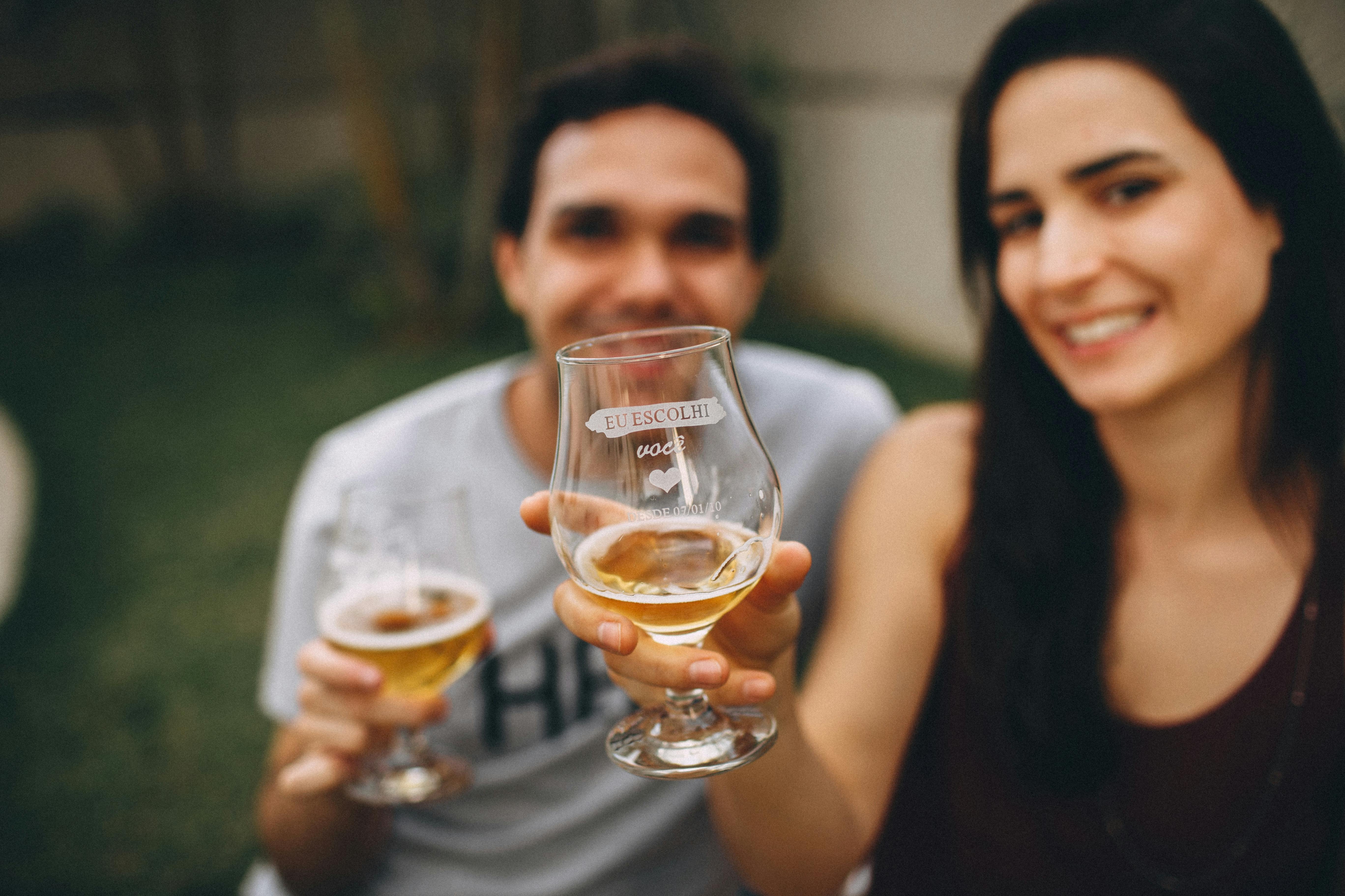 Man And Woman Holding Clear Drinking Glass Free Stock Photo