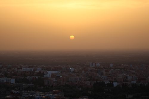 Free A stunning sunset view over Beni Mellal, Morocco, capturing the city's silhouette against a warm evening sky. Stock Photo