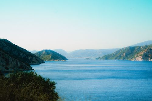 Free Breathtaking view of Marmaris' tranquil blue sea and green hills under a clear sky. Stock Photo