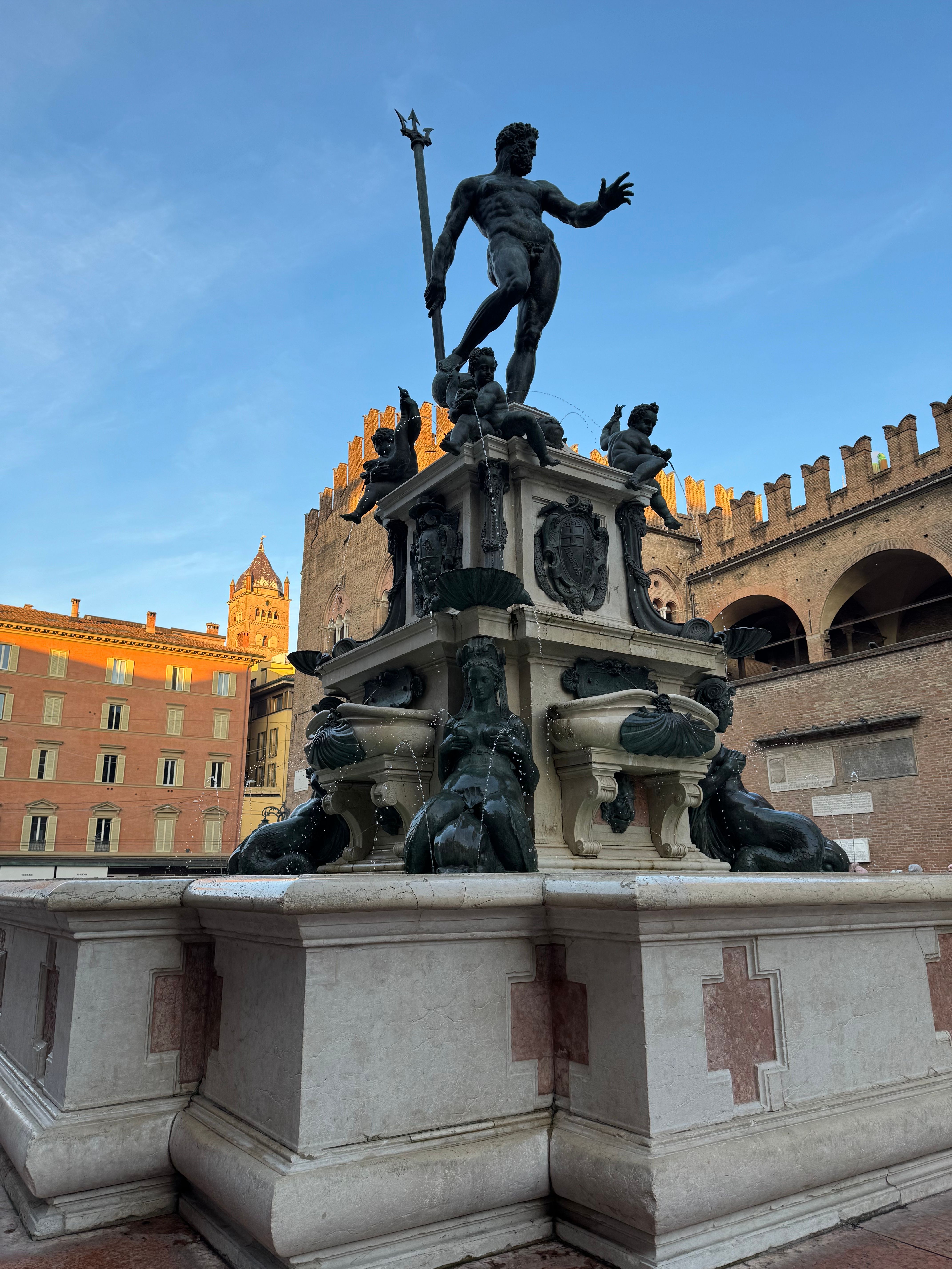 A stunning view of the Neptune Fountain in Bologna, Italy, captured at sunset.