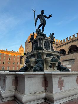 A stunning view of the Neptune Fountain in Bologna, Italy, captured at sunset.