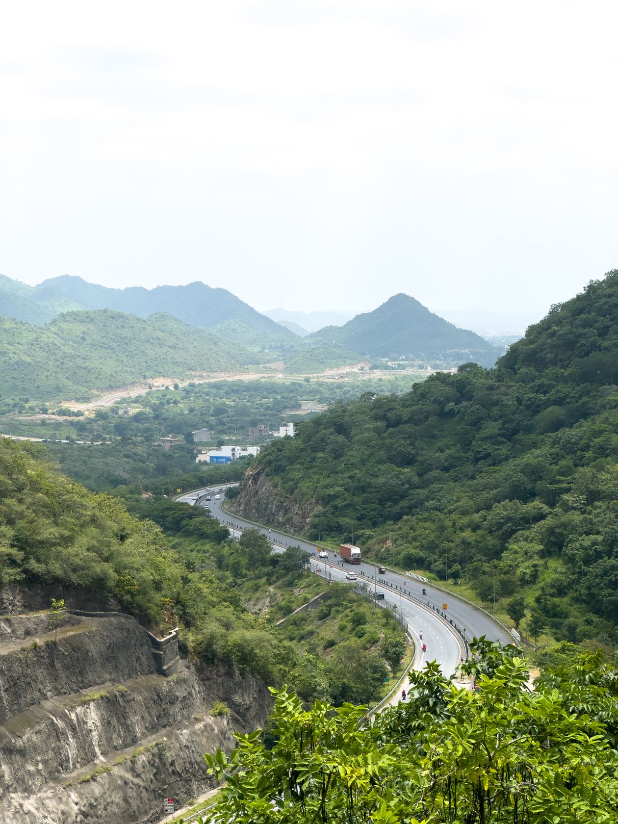 Winding road through green Aravalli hills in Rajasthan near Udaipur