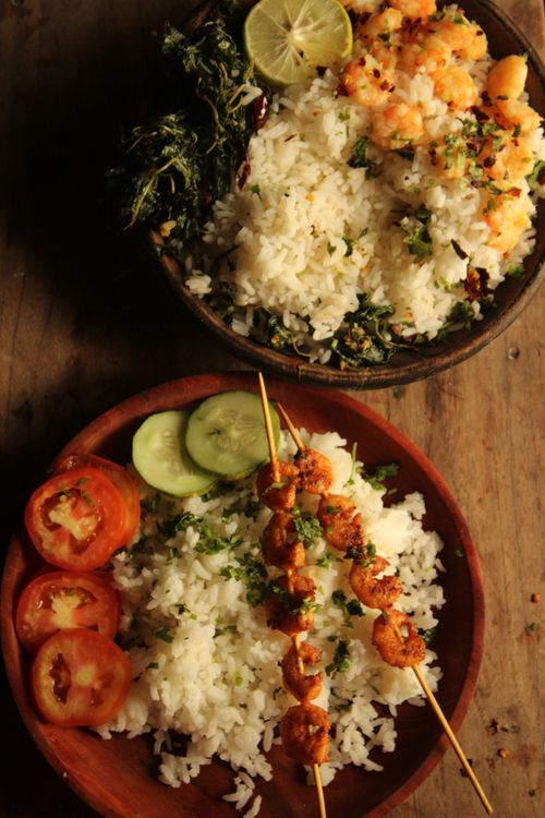 Free Appetizing seafood and rice dish served with fresh vegetables and herbs, perfect for a gourmet meal. Stock Photo