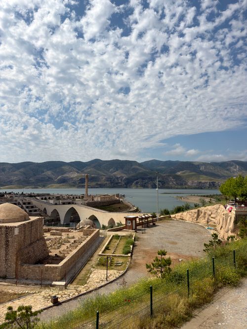 Free Scenic view of the Euphrates River and historic architecture under a cloudy sky. Stock Photo