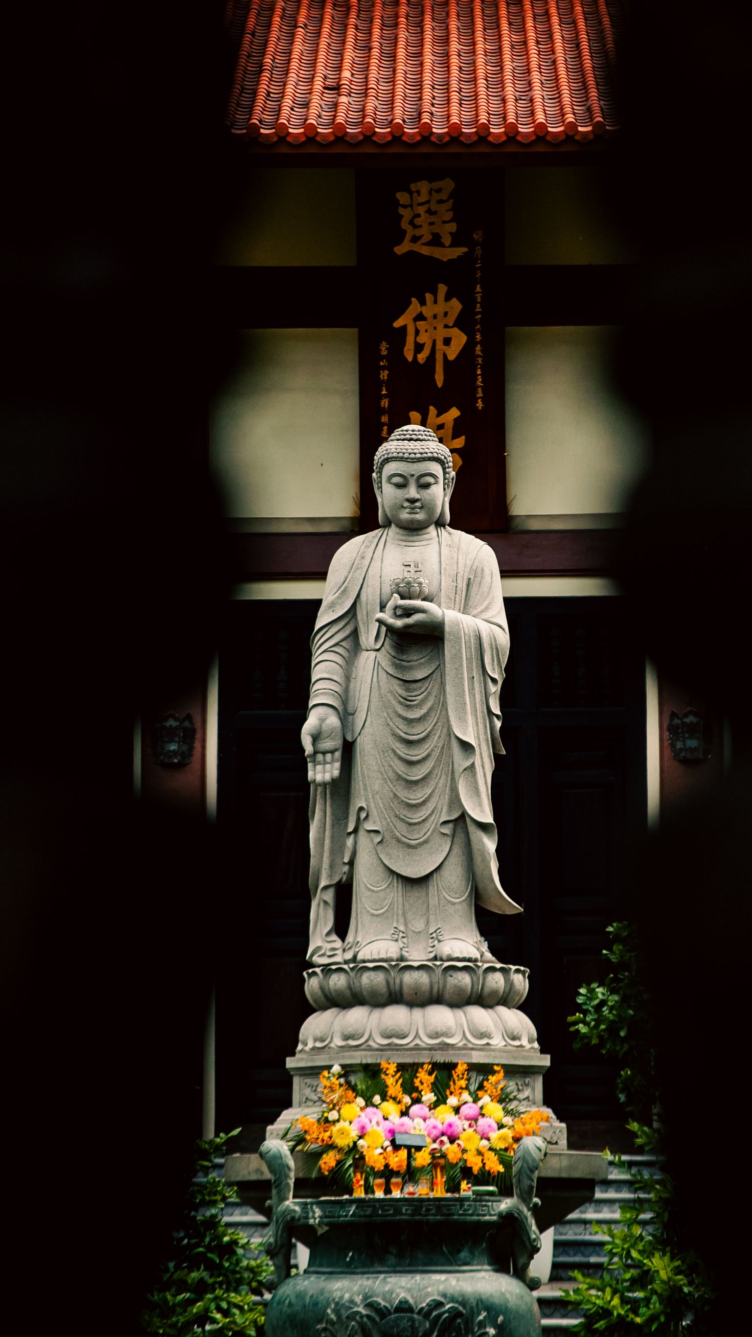 Serene Buddha statue in a Vietnamese temple's courtyard, Ho Chi Minh City, Vietnam.