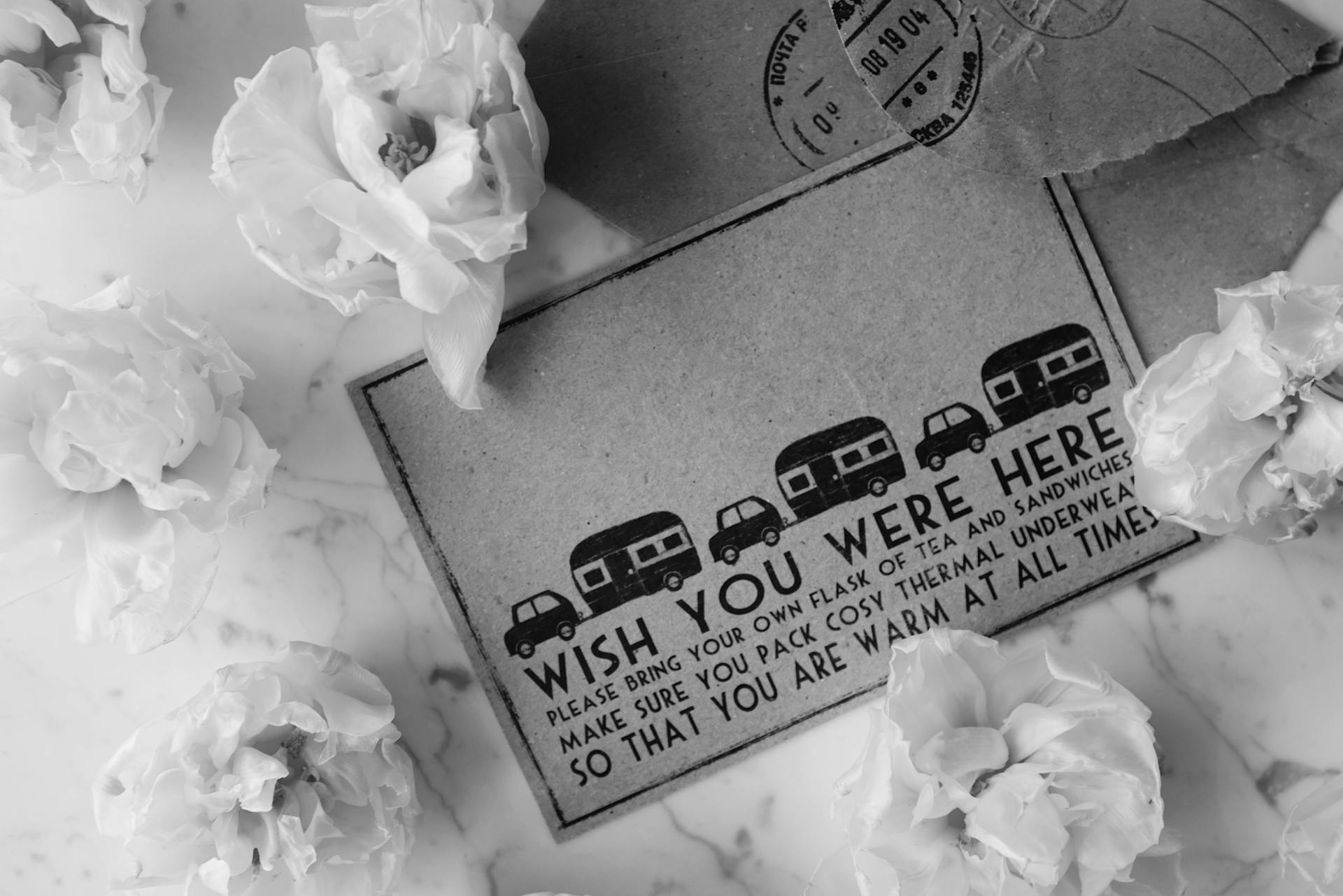 Monochrome postcard with floral decor, perfect for sentimental traveling memories.