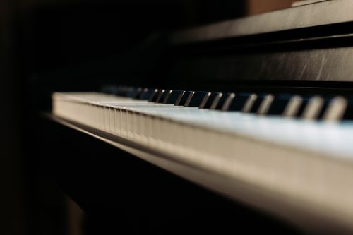 Free A close-up shot of piano keys with warm lighting, capturing musical elegance. Stock Photo