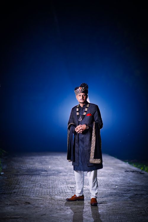 Free A man in traditional Indian clothing standing outdoors at night. Elegant and cultural representation. Stock Photo
